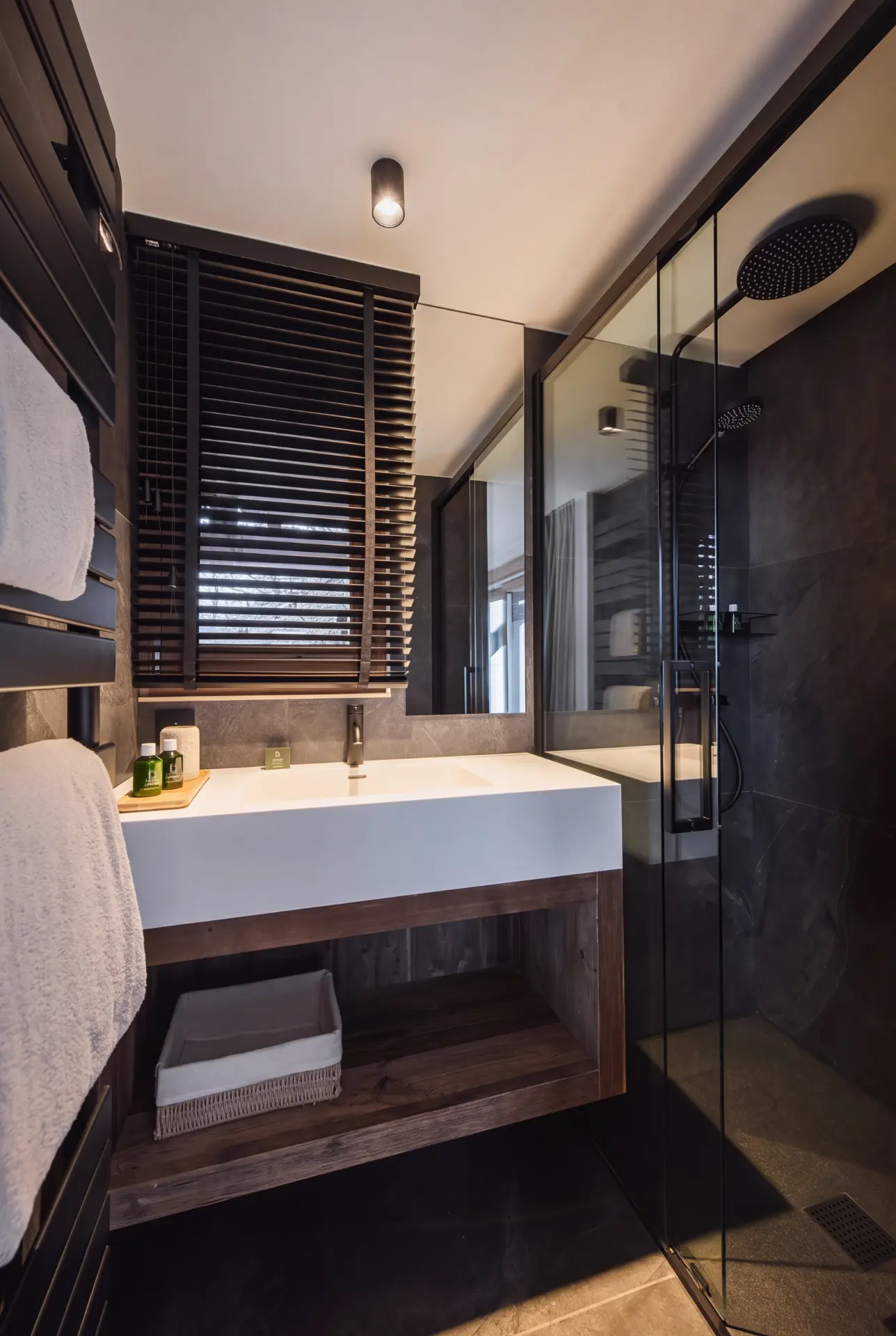 Dark stone bathroom with walk-in shower