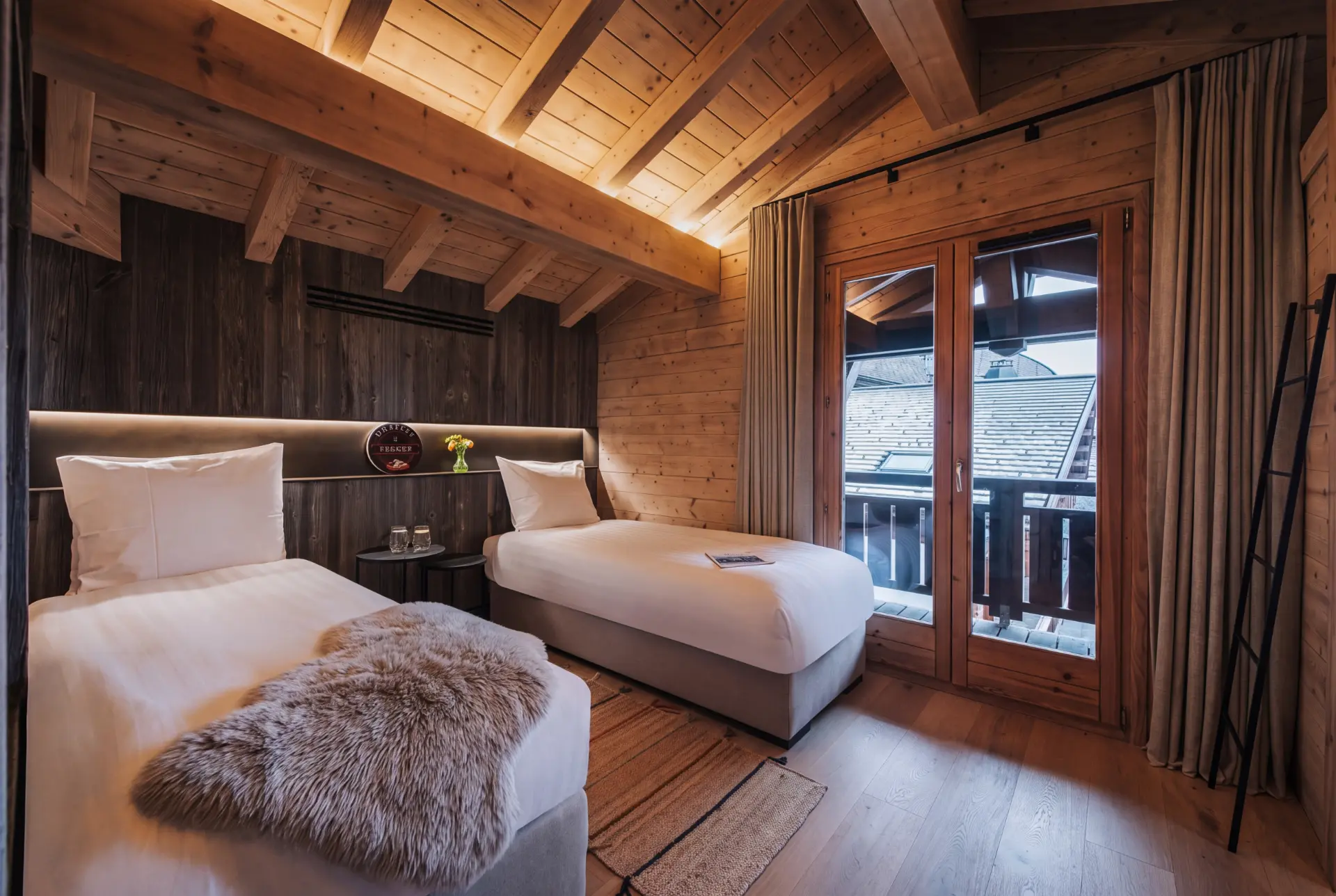 Twin bedroom with sheepskin throws