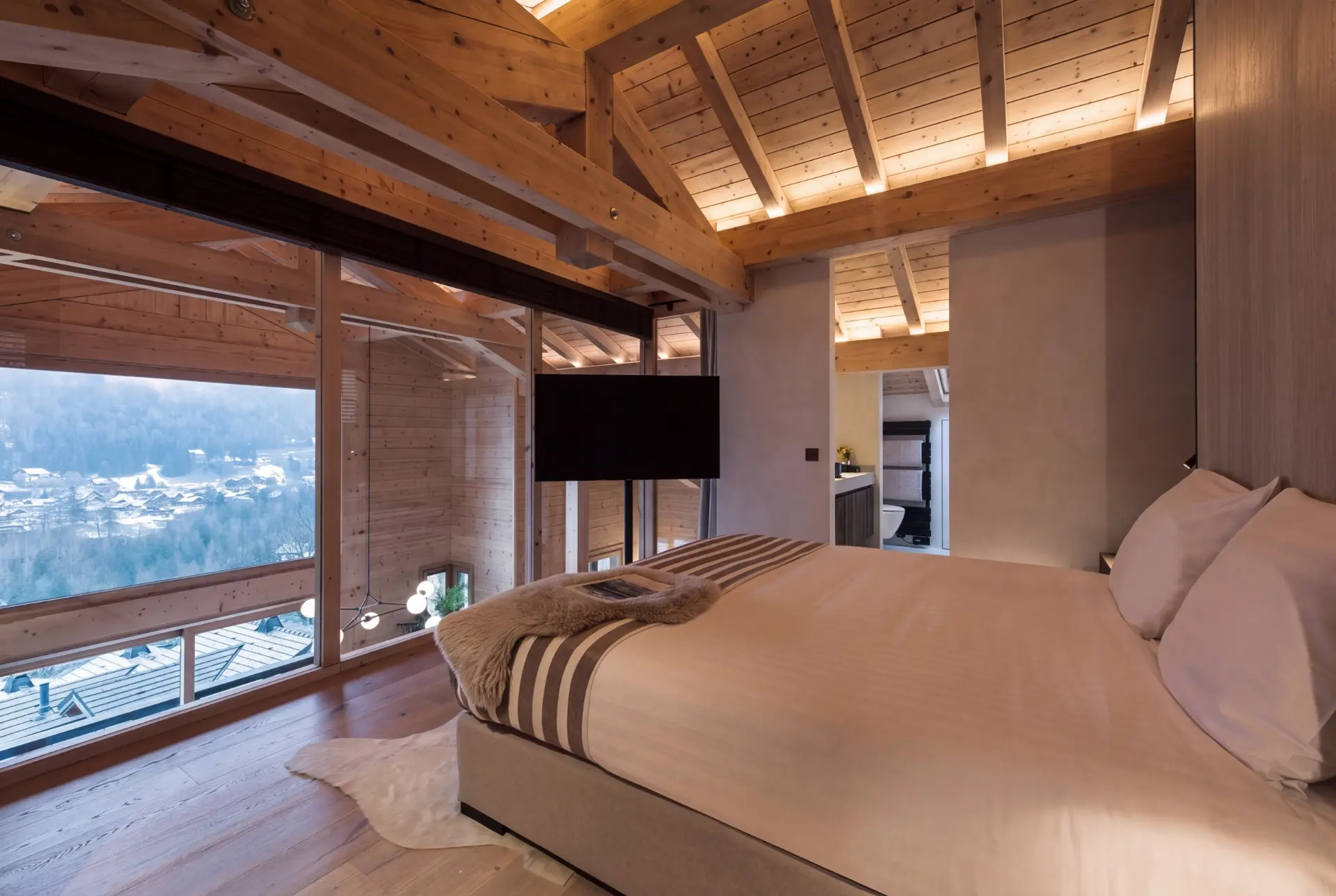 Master bedroom with mountain views and pale timber walls
